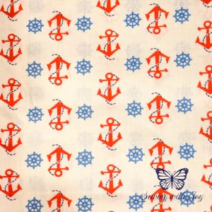 White fabric with red anchors and blue wheels for fall capsule wardrobe